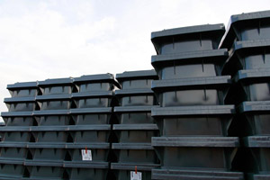 Neue Restabfalltonnen warten auf Auslieferung an die Kunden: Graue Abfallbehälter in Stapeln